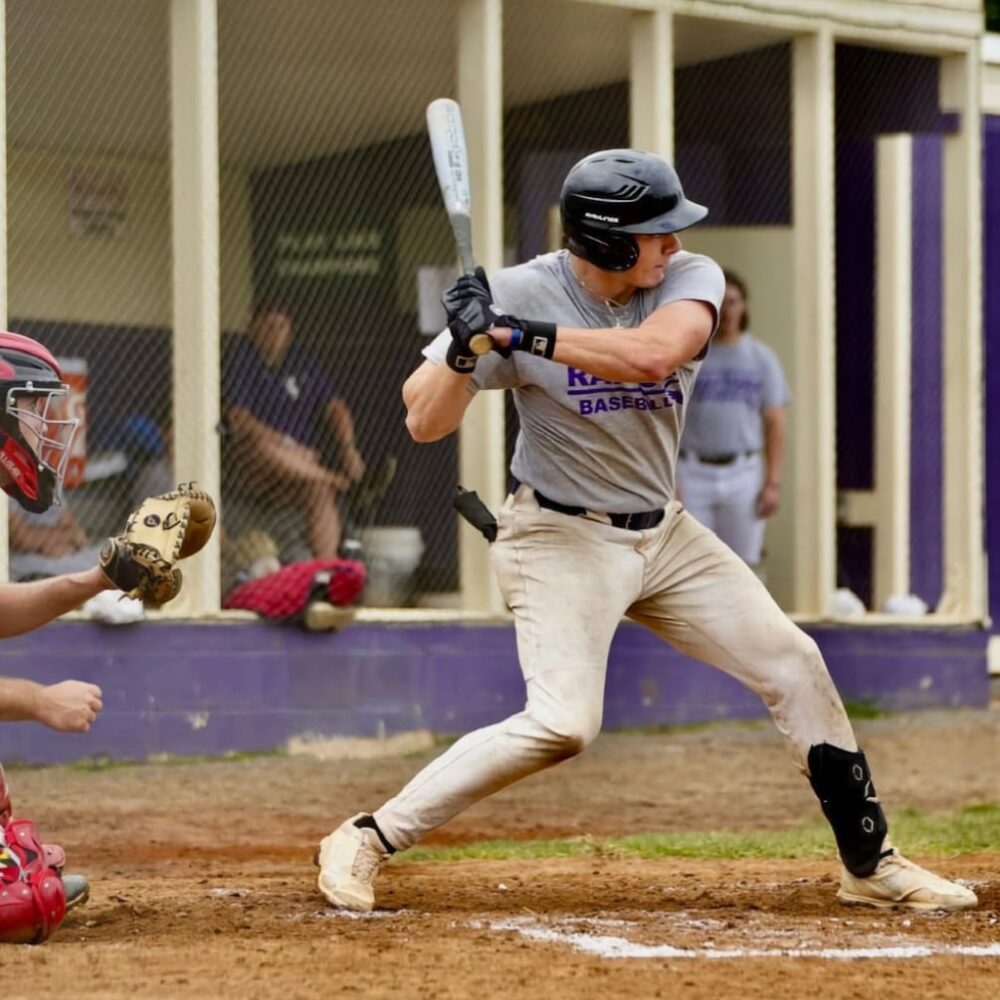 Jackson Freeman swinging during a college baseball game — HammerZone Sports instructor