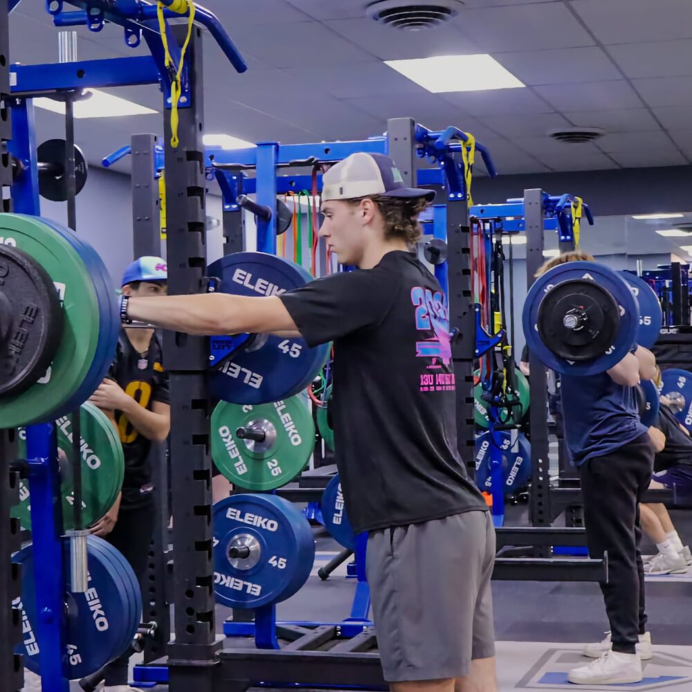 Athletes training with free weights inside the HammerZone Performance Training facility