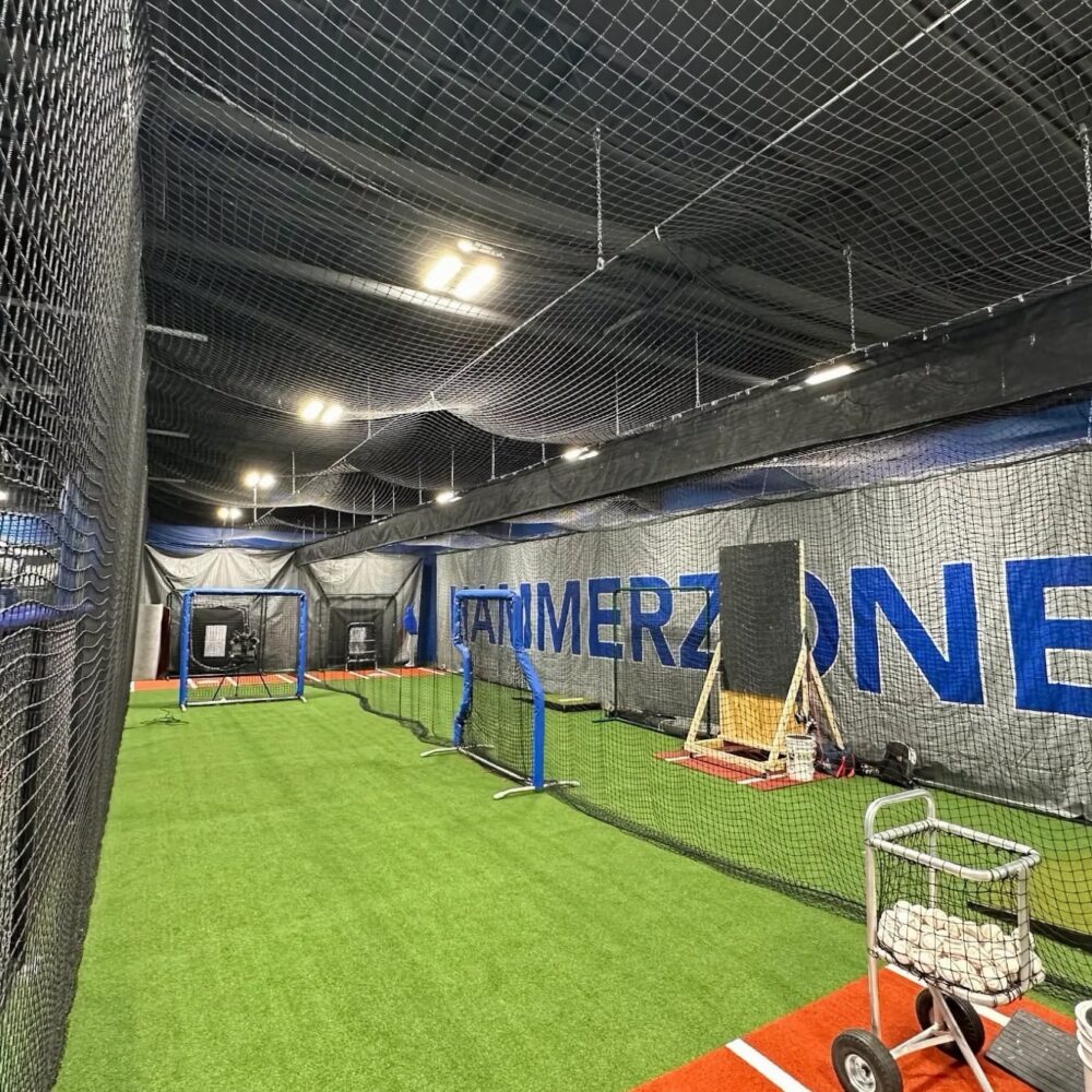 Indoor batting cages at the HammerZone Sports facility with HammerZone signage