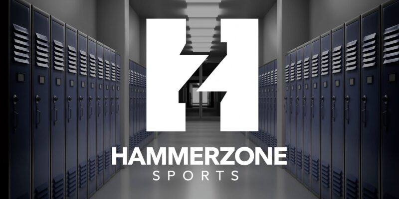 Empty hallway lined with blue lockers at the HammerZone Sports baseball training facility